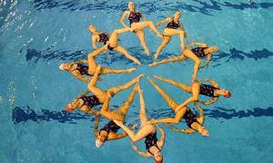 Women forming a circle in the pool. 