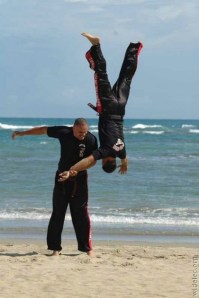 A man in the air after a brazilian jujitsu throw. 