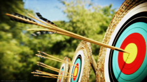 An arrow splitting another arrow on a bullseye target. 