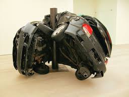 A car wrapped around a pole. It's art, or something