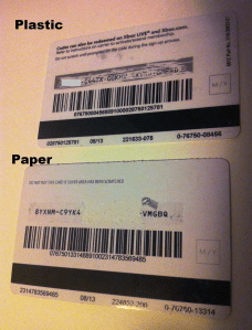 The backs of the two cards, showing how the plastic card scratched and the paper card ripped. 