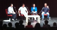 A blurry picture of four people on a stage.